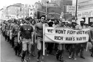 Antiwar marches holding banner - we won't fight another rich man's war